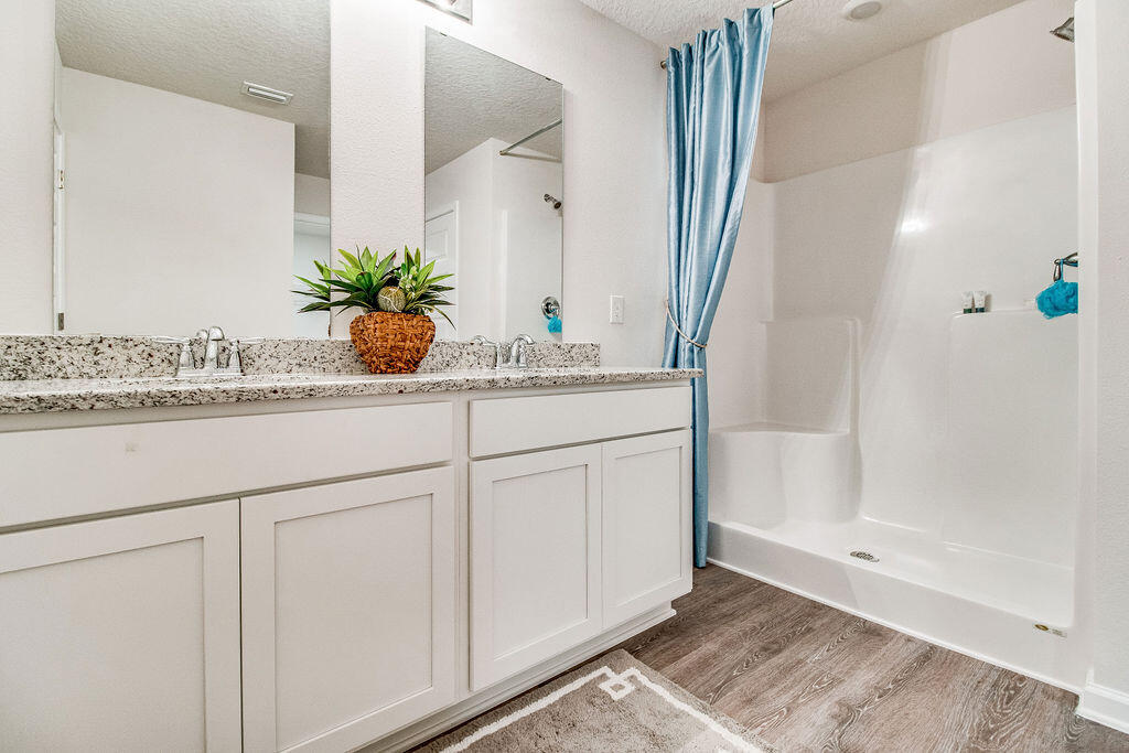 331 Flounder Street Crestview, FL 32539 - Photo 15 of 31 a bathroom with cabinets and mirror