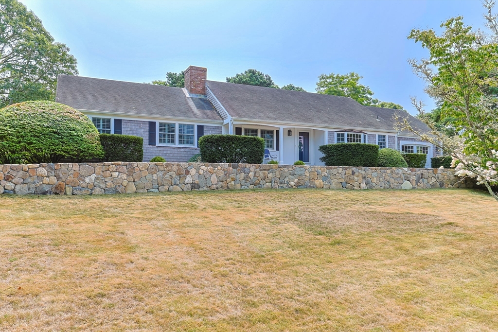 56 Riverview Drive Chatham, MA 02633 - Photo 1 of 37 a front view of house with yard and trees around
