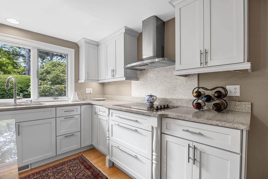 56 Riverview Drive Chatham, MA 02633 - Photo 15 of 37 a kitchen with stainless steel appliances granite countertop white cabinets and a window