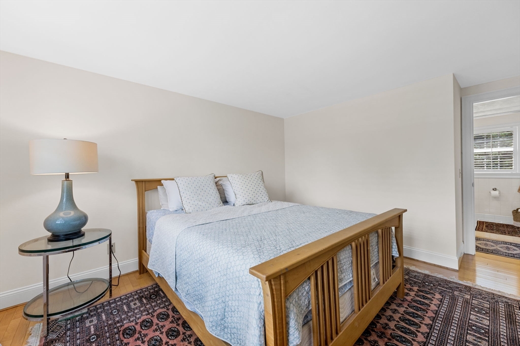 56 Riverview Drive Chatham, MA 02633 - Photo 19 of 37 a bedroom with a bed and a table in it