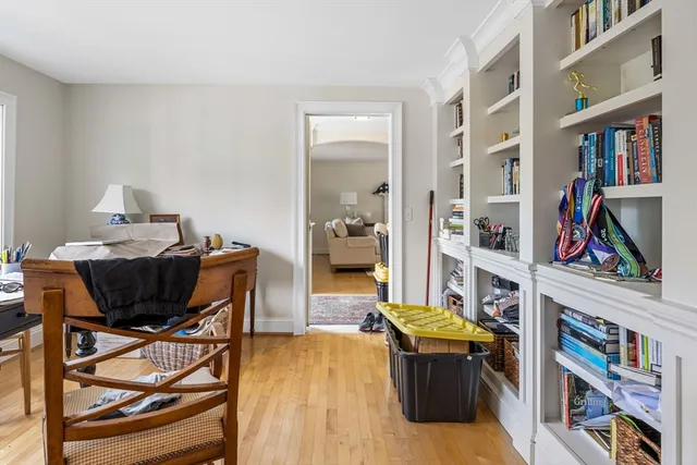 a living room with furniture and a book shelf