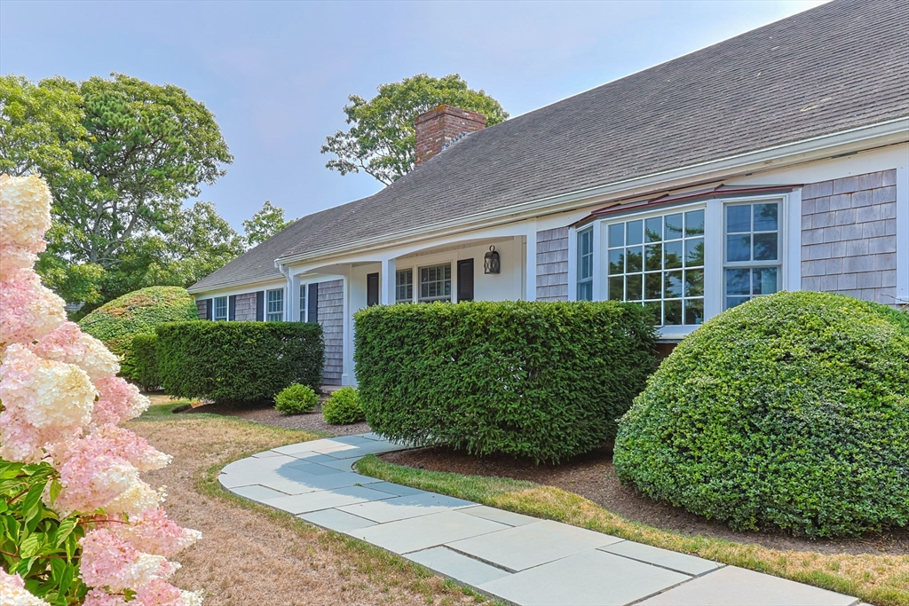 56 Riverview Drive Chatham, MA 02633 - Photo 3 of 37 a front view of a house with garden and plants