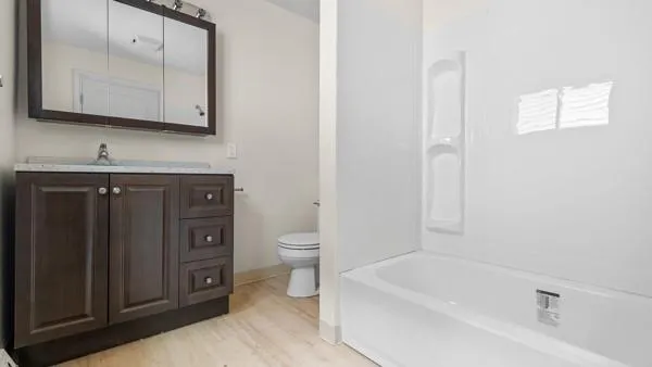 a bathroom with a sink a toilet and bathtub
