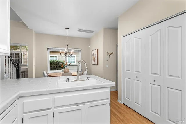 a dining room with furniture a chandelier and wooden floor