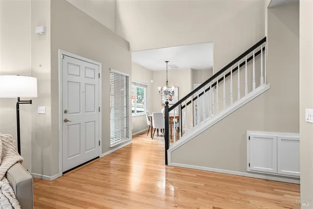 a view of entryway and hall with wooden floor