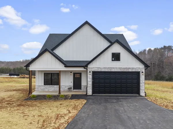 a front view of a house with a yard and garage
