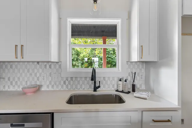 a kitchen with a sink and cabinets