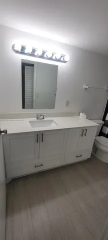 a bathroom with a sink and cabinets
