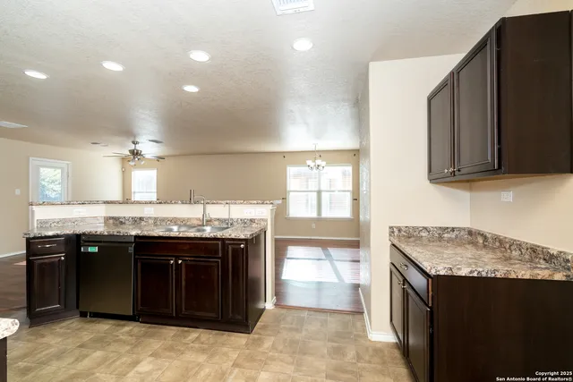 a kitchen with a sink and a stove top oven