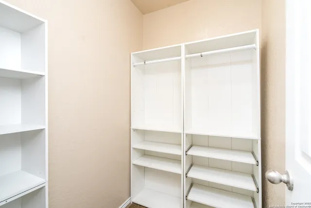 a view of an empty walk in closet