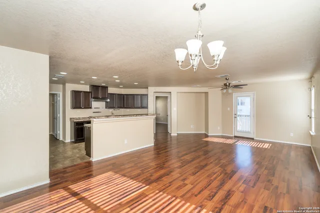a view of a kitchen with stove and wooden floor