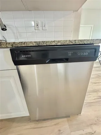 a kitchen with stainless steel appliances granite countertop a sink stove and microwave