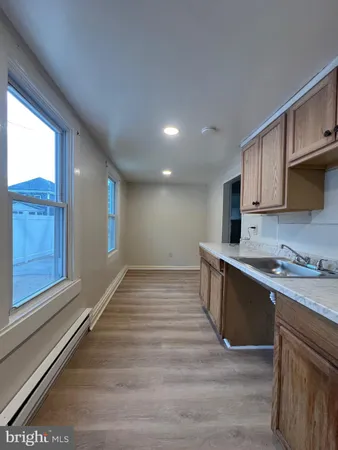 a kitchen with stainless steel appliances granite countertop a sink stove and wooden cabinets