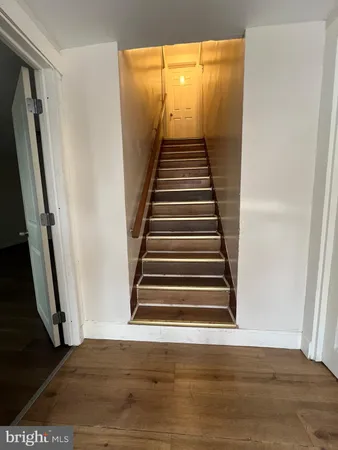 a view of a room with wooden floor and stairs