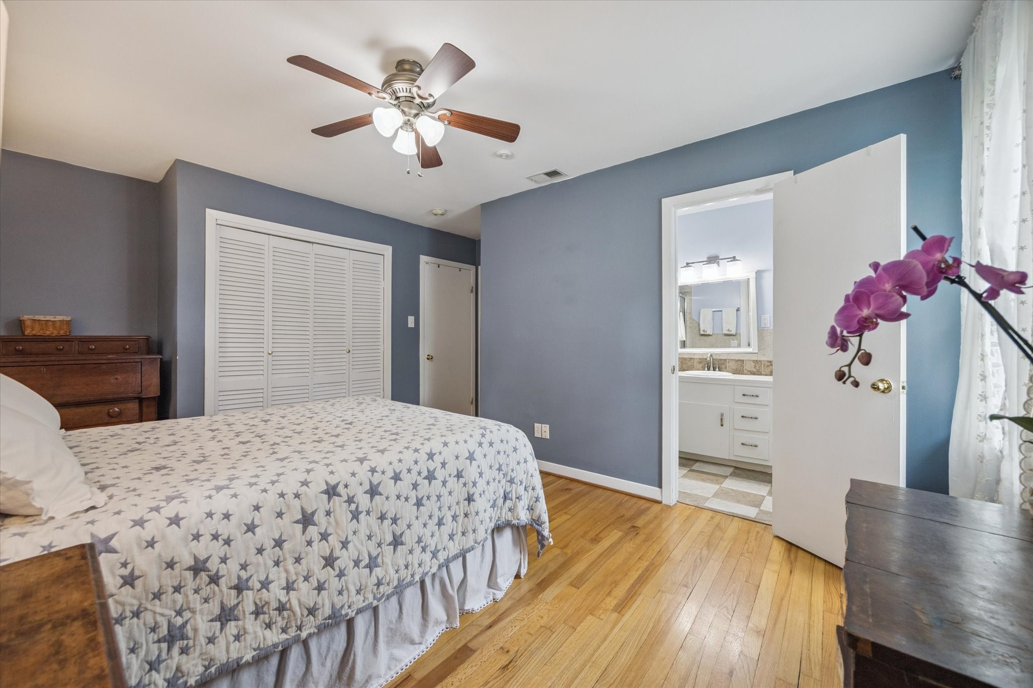 5114 Kinglet Street Houston, TX 77035 - Photo 13 of 20 a bedroom with a bed and wooden floor