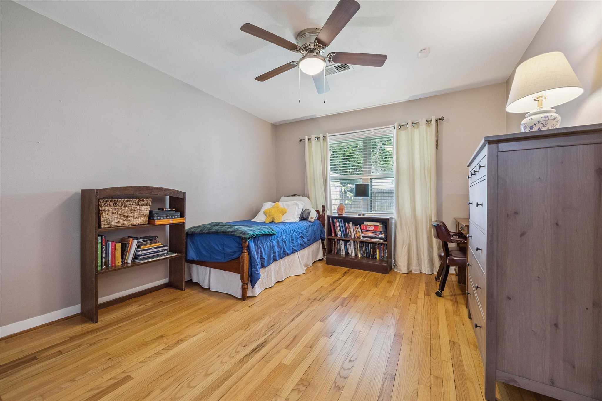 5114 Kinglet Street Houston, TX 77035 - Photo 15 of 20 a bedroom with furniture and a window