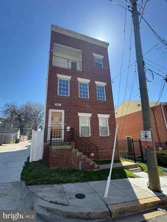 a view of a brick house with a yard