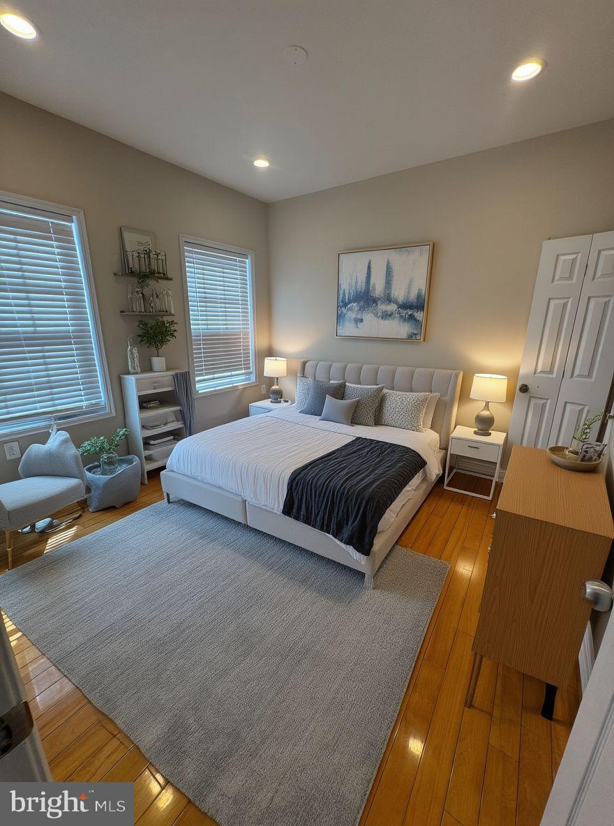 2239 Ridge Place Southeast Washington, DC 20020 - Photo 19 of 44 a bedroom with a bed and wooden floor