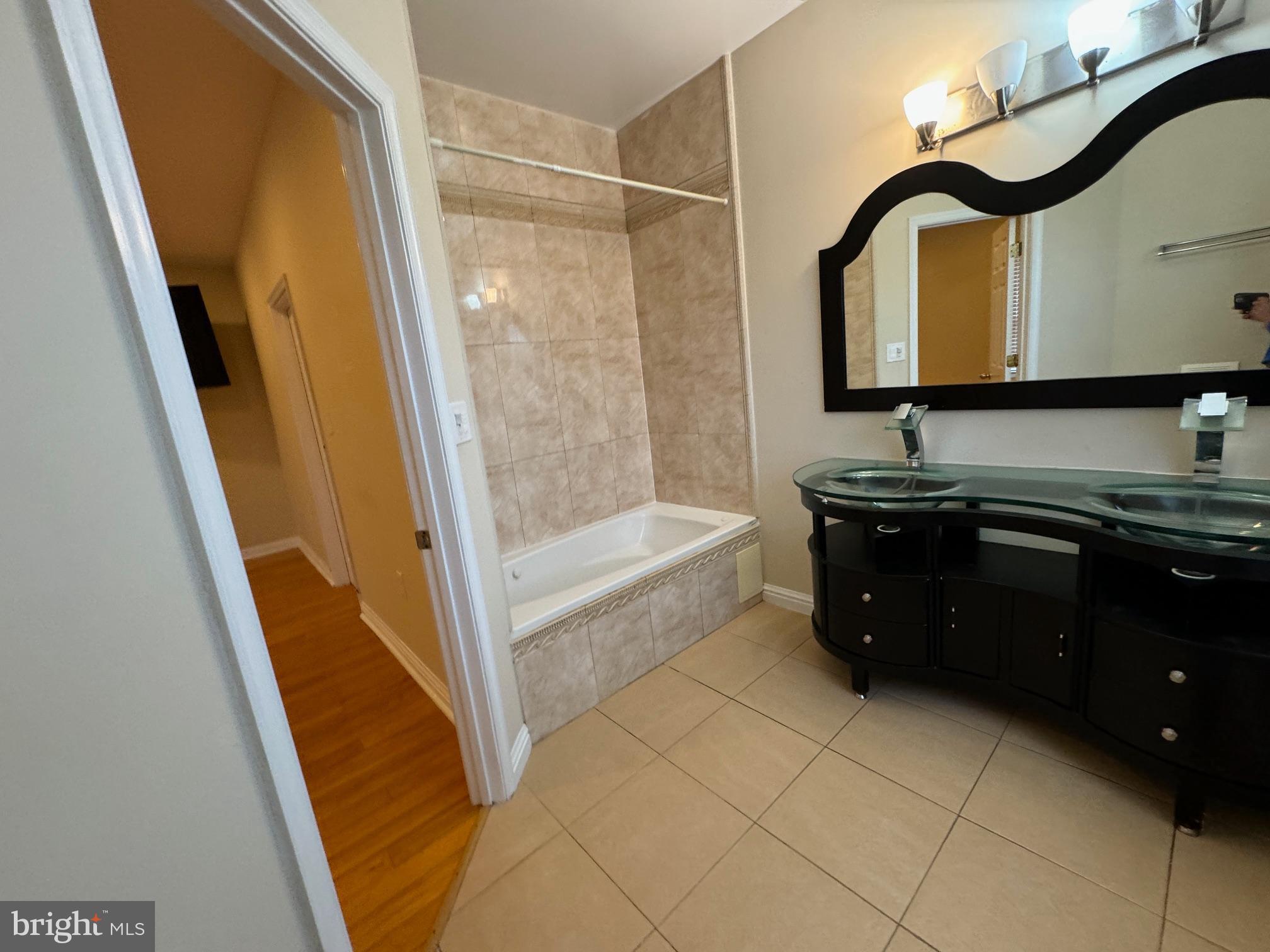 2239 Ridge Place Southeast Washington, DC 20020 - Photo 24 of 44 a bathroom with a sink a mirror and a bathtub