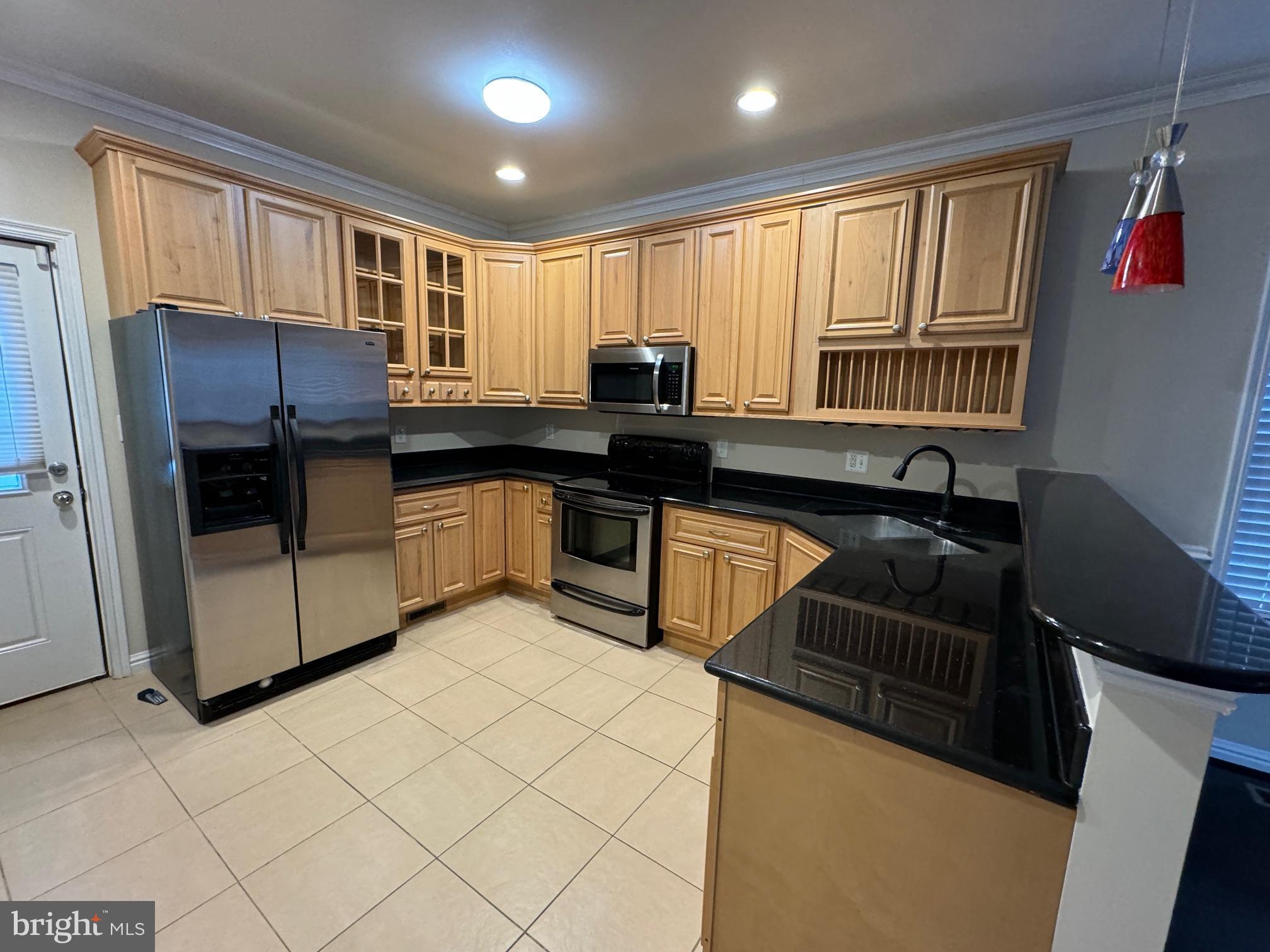 2239 Ridge Place Southeast Washington, DC 20020 - Photo 3 of 44 a kitchen with granite countertop a stove a sink and a refrigerator