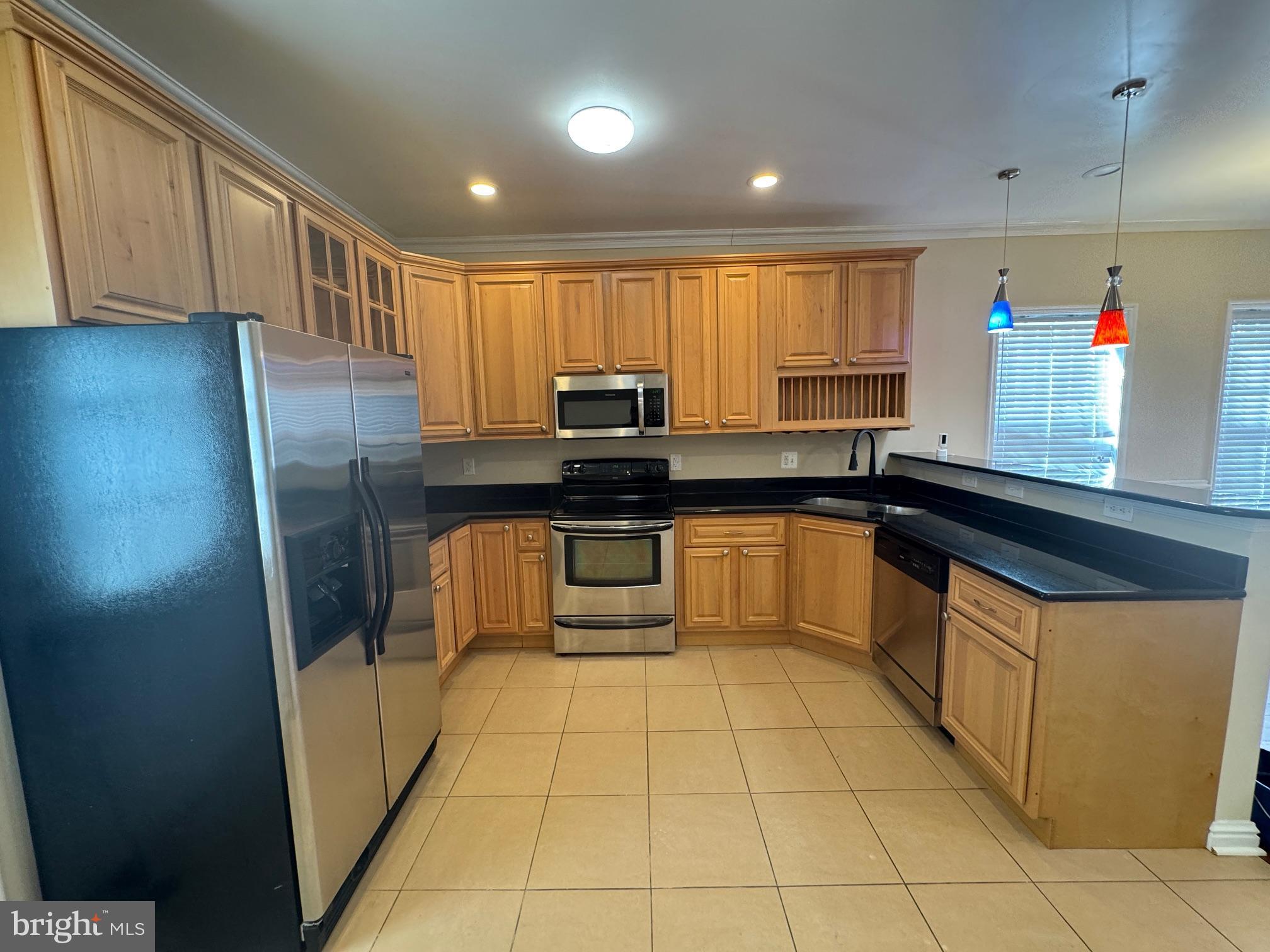 2239 Ridge Place Southeast Washington, DC 20020 - Photo 4 of 44 a kitchen with stainless steel appliances granite countertop a sink stove and refrigerator