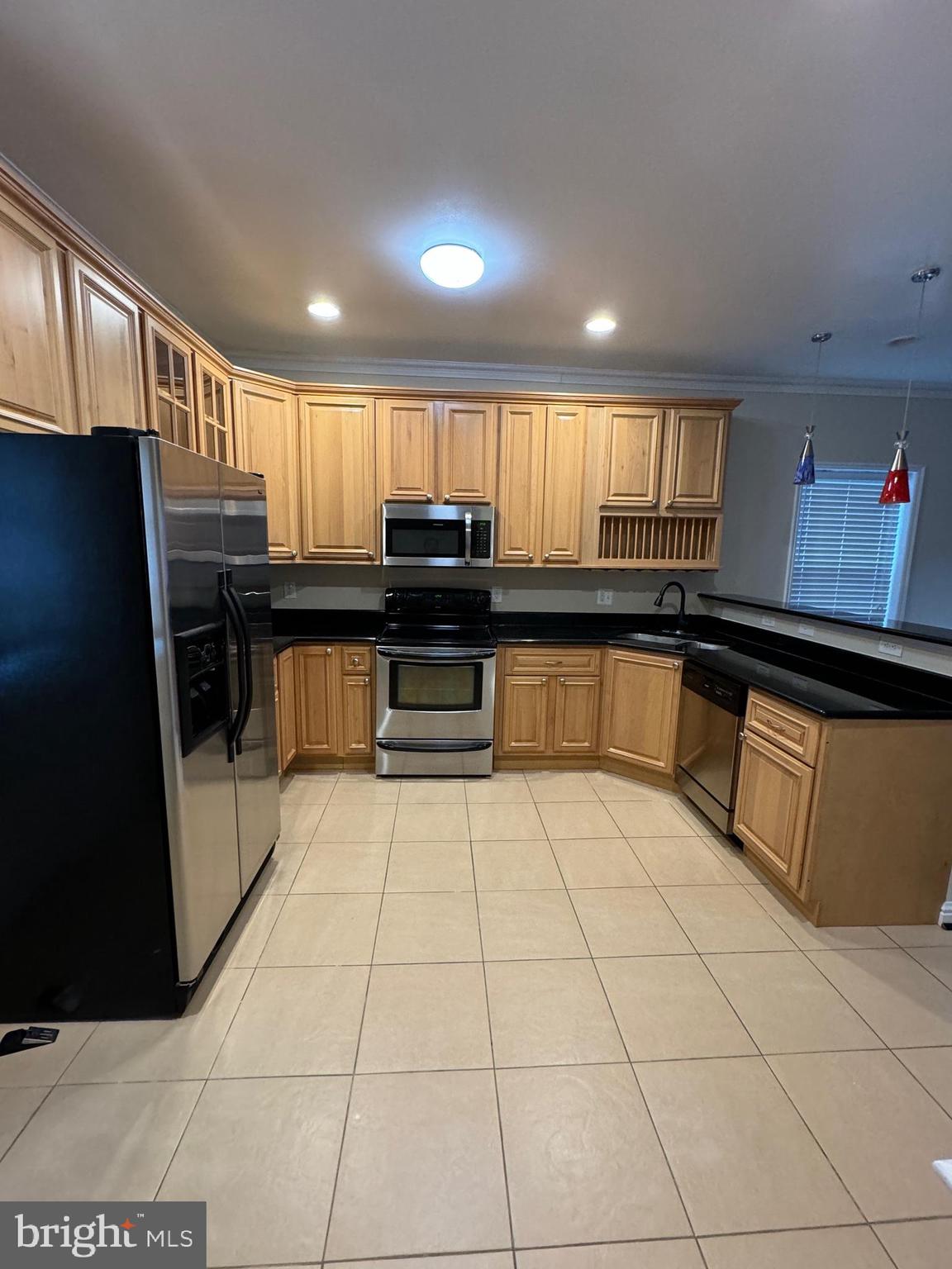2239 Ridge Place Southeast Washington, DC 20020 - Photo 5 of 44 a kitchen with stainless steel appliances granite countertop a sink and cabinets
