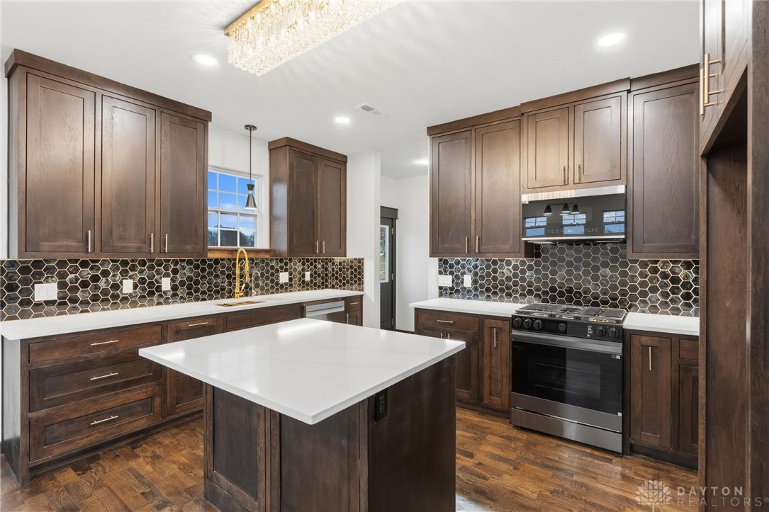 3509 South State Rte 72 Sabina, OH 45169 - Photo 13 of 44 This modern kitchen features a spacious island, sleek appliances, and elegant tile work.
