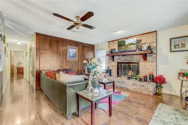 a living room with furniture a fireplace and a flat screen tv