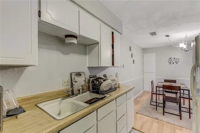 a kitchen with a sink cabinets and appliances