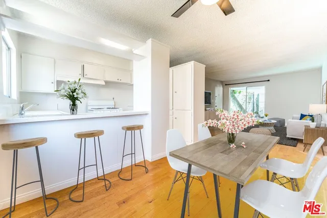 a view of a dining room with furniture and a chandelier