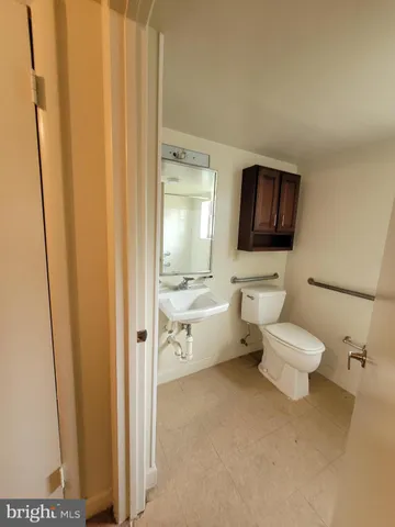 a view of a refrigerator in kitchen and utility room