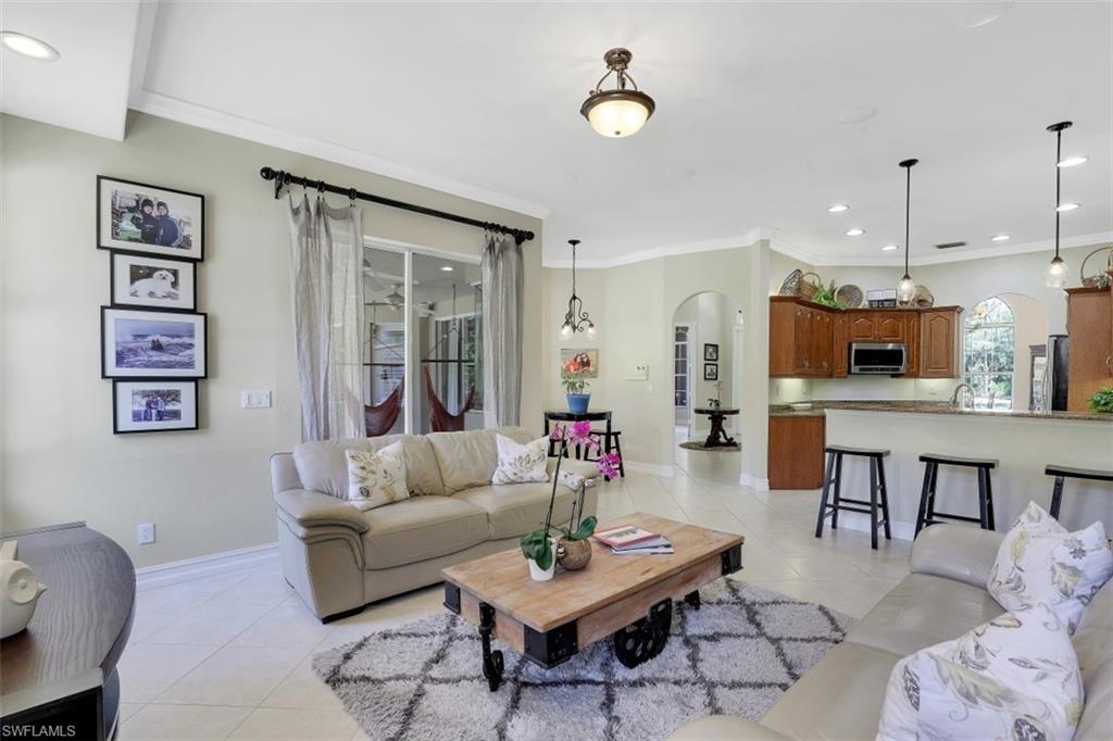 4364 6th Avenue Southeast Naples, FL 34117 - Photo 12 of 35 a living room with furniture kitchen view and a wooden floor
