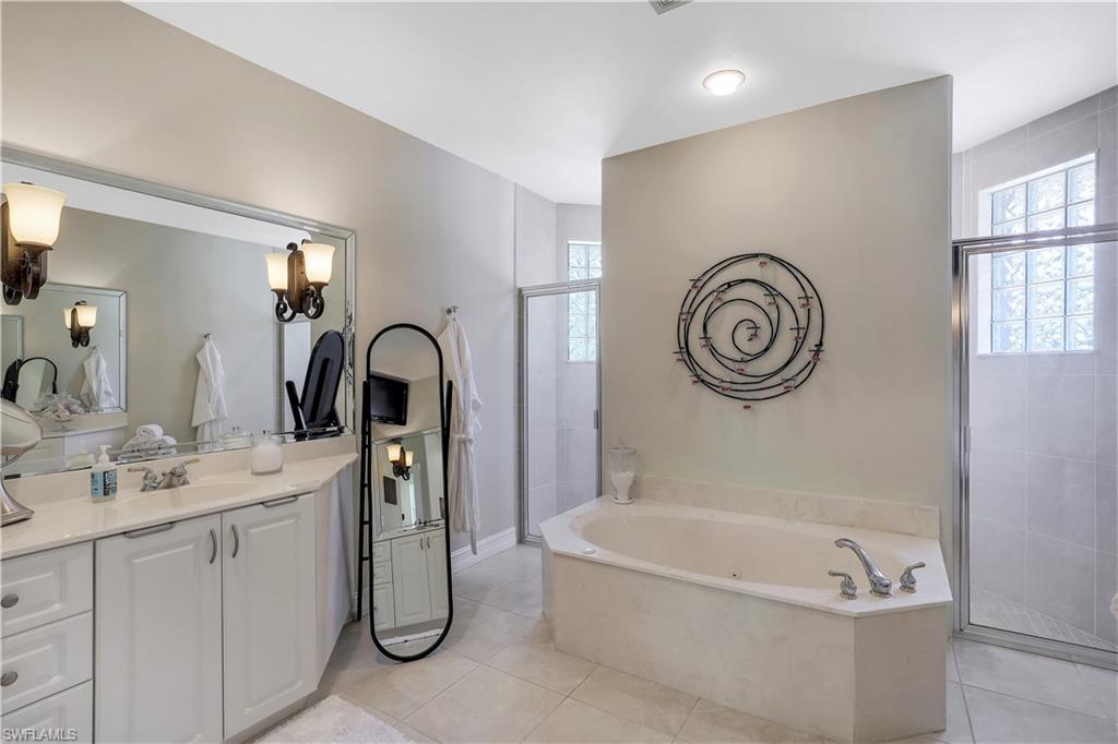 4364 6th Avenue Southeast Naples, FL 34117 - Photo 16 of 35 a bathroom with a tub sink and mirror
