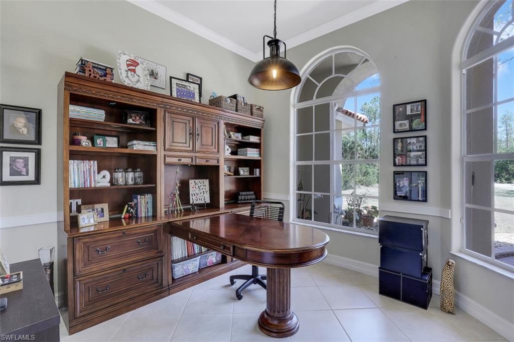 4364 6th Avenue Southeast Naples, FL 34117 - Photo 20 of 35 a dining room with furniture and a chandelier