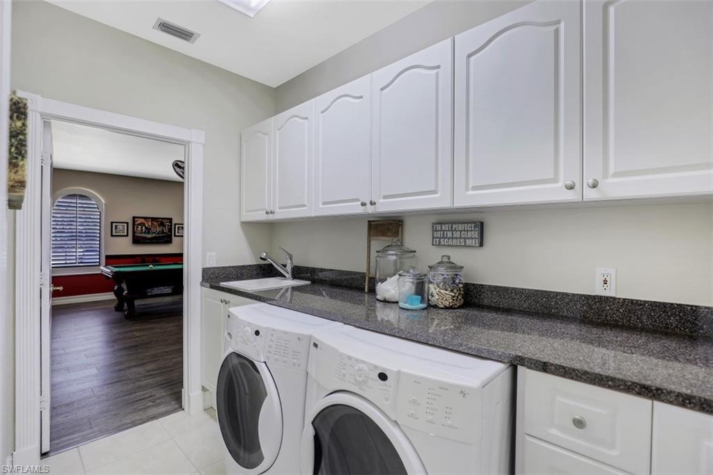 4364 6th Avenue Southeast Naples, FL 34117 - Photo 21 of 35 a kitchen with granite countertop a sink a stove and cabinets