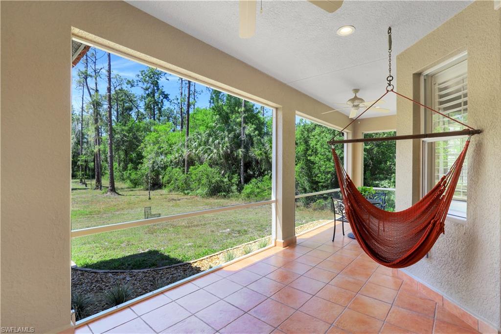4364 6th Avenue Southeast Naples, FL 34117 - Photo 23 of 35 a view of a porch with a floor to ceiling window and a yard