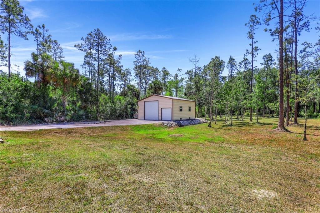 4364 6th Avenue Southeast Naples, FL 34117 - Photo 26 of 35 a view of a backyard with swimming pool