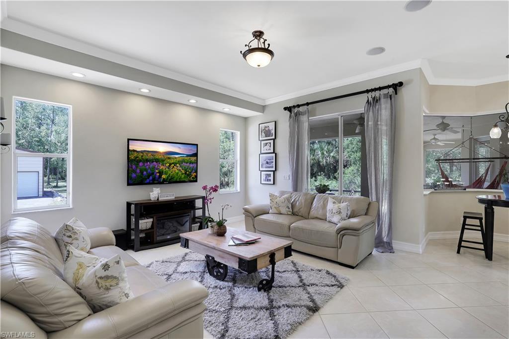 4364 6th Avenue Southeast Naples, FL 34117 - Photo 4 of 35 a living room with furniture a flat screen tv and a large window