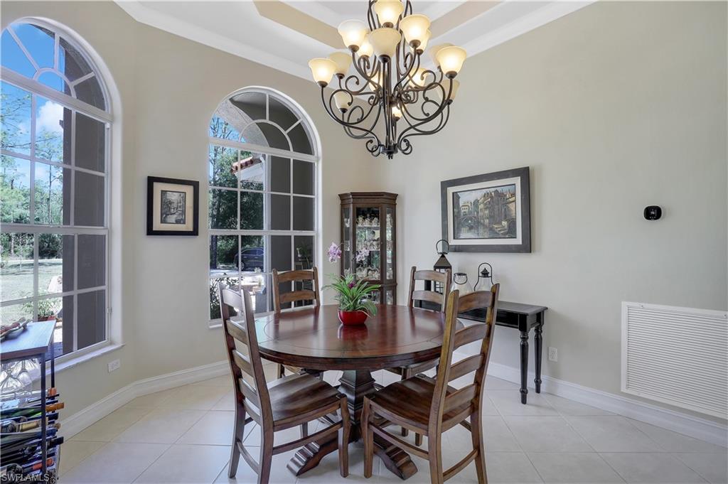 4364 6th Avenue Southeast Naples, FL 34117 - Photo 7 of 35 a view of a dining room with furniture a chandelier and wooden floor
