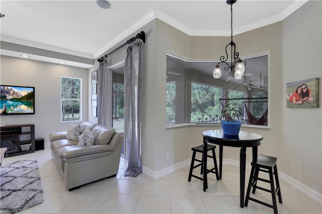 4364 6th Avenue Southeast Naples, FL 34117 - Photo 8 of 35 a living room with furniture a window and a flat screen tv
