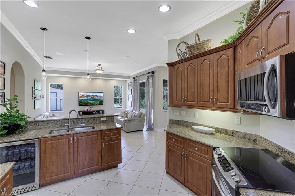 4364 6th Avenue Southeast Naples, FL 34117 - Photo 10 of 35 a kitchen with a sink stove and cabinets