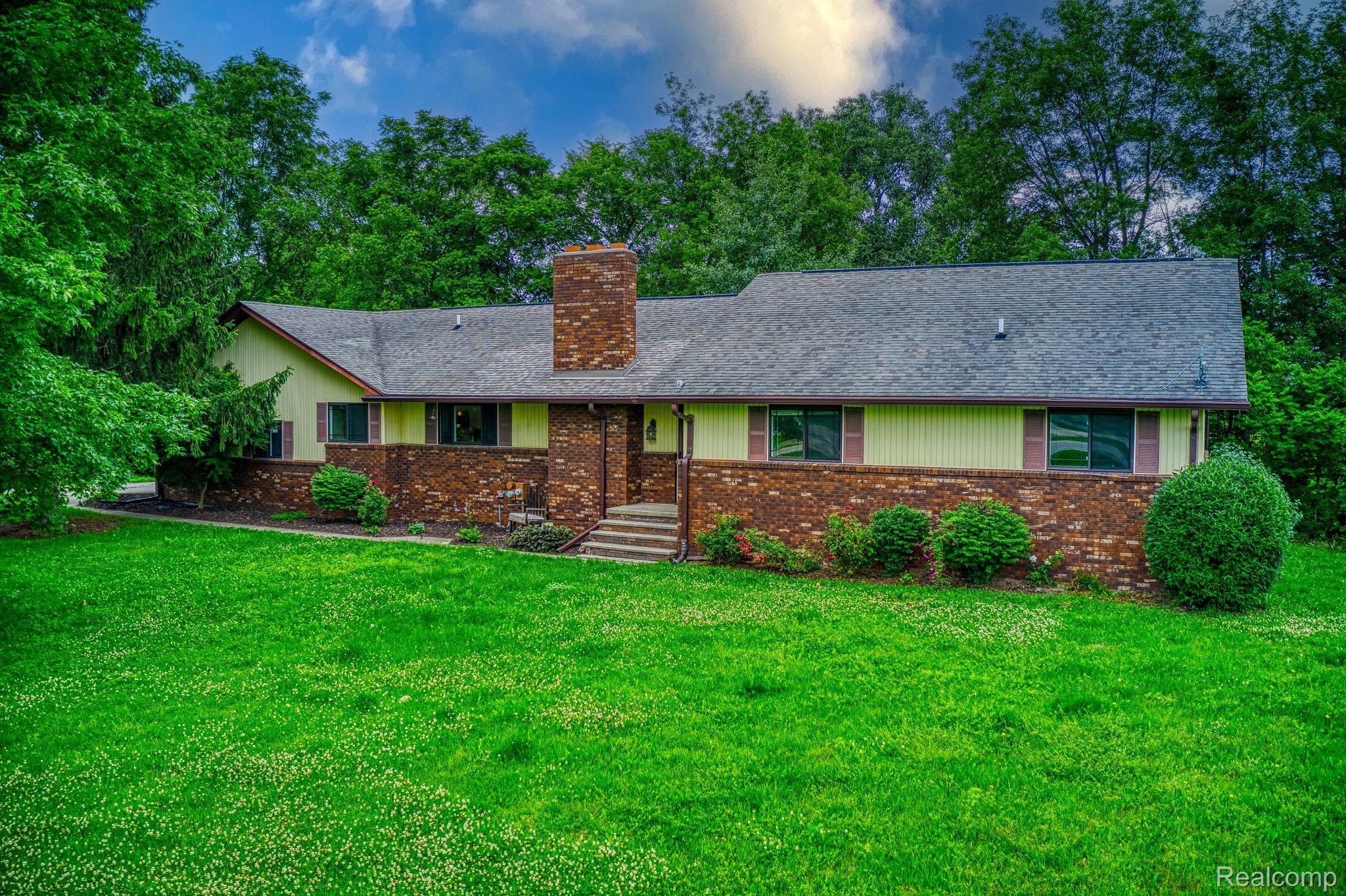 12012 Belle River Road Memphis, MI 48041 - Photo 33 of 41 Ranch-style house featuring brick siding, a front lawn, a chimney, and roof with shingles