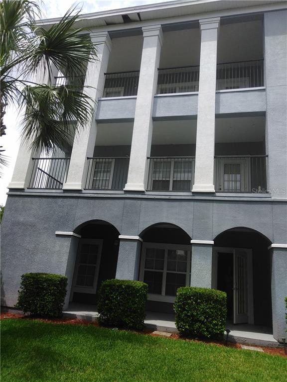 3589 Conroy Road, Unit 1015 Orlando, FL 32839 - Photo 1 of 1 a front view of a house with a garden
