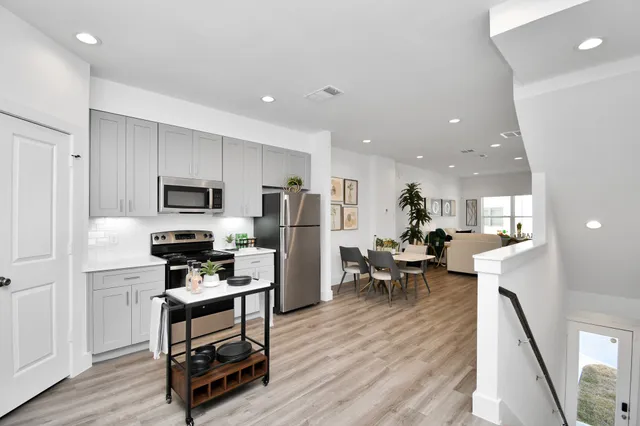 a kitchen with stainless steel appliances a refrigerator and a stove top oven