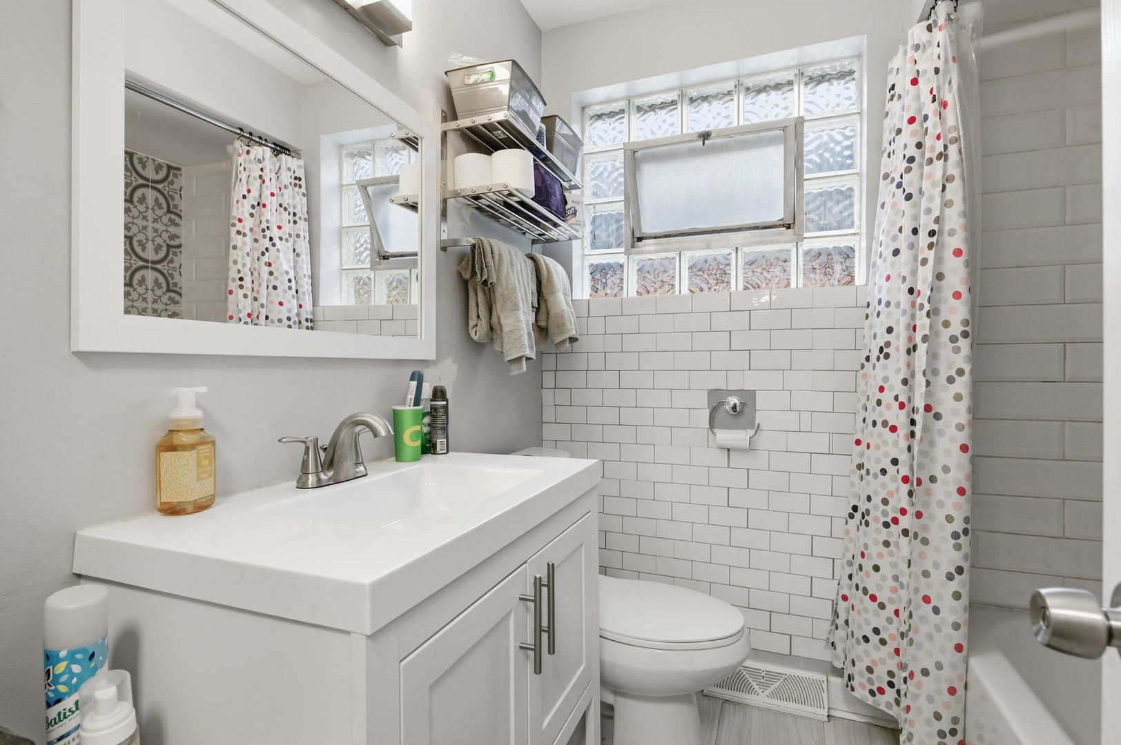1036 West 105th Street Chicago, IL 60643 - Photo 15 of 30 a bathroom with a sink a toilet and shower curtain