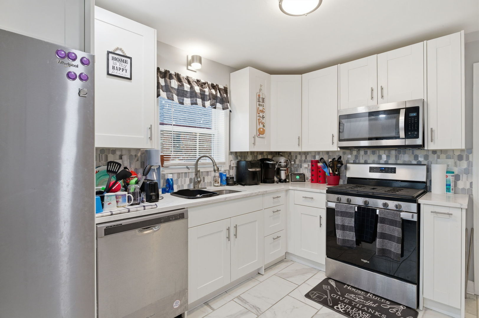 1036 West 105th Street Chicago, IL 60643 - Photo 7 of 30 a kitchen with a sink cabinets and stainless steel appliances