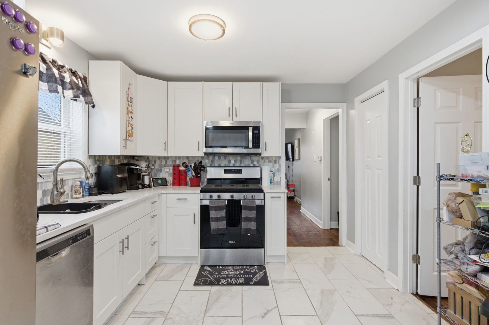 1036 West 105th Street Chicago, IL 60643 - Photo 8 of 30 a kitchen with white cabinets and appliances