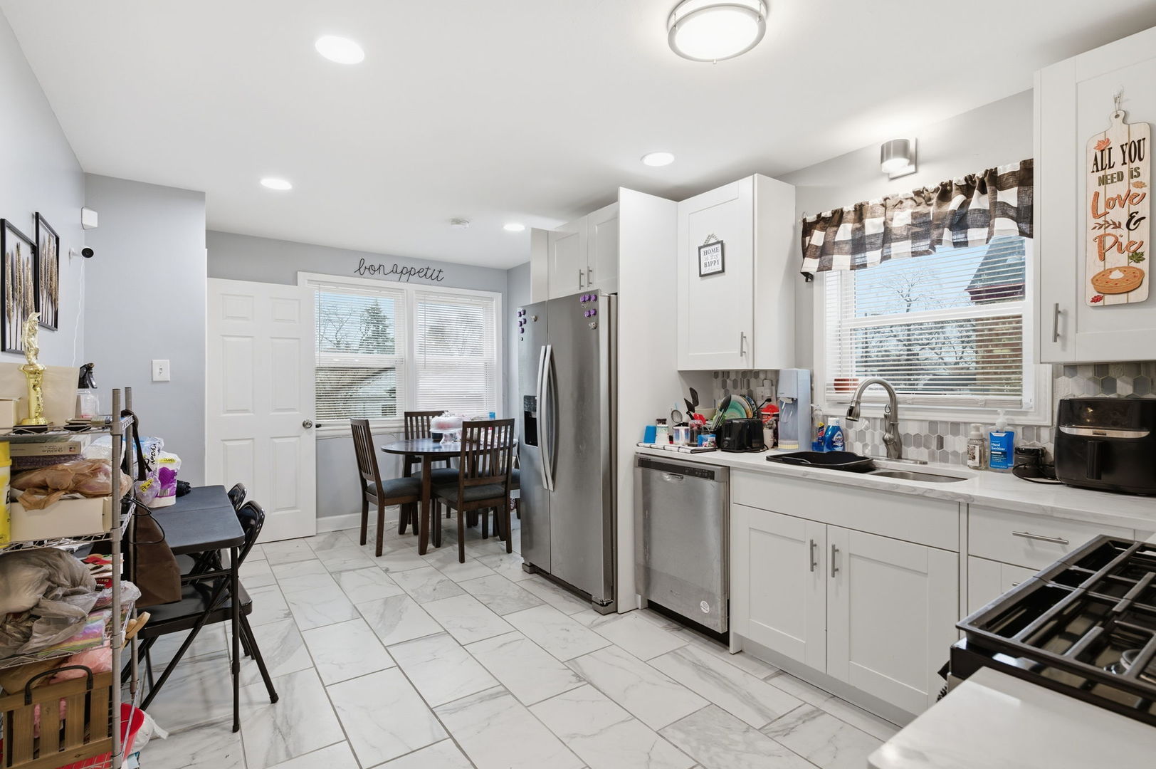 1036 West 105th Street Chicago, IL 60643 - Photo 9 of 30 a kitchen with a sink and chairs