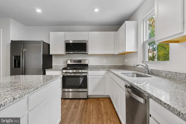 a kitchen with a sink stove and refrigerator