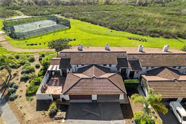 an aerial view of a house with a garden and lake view